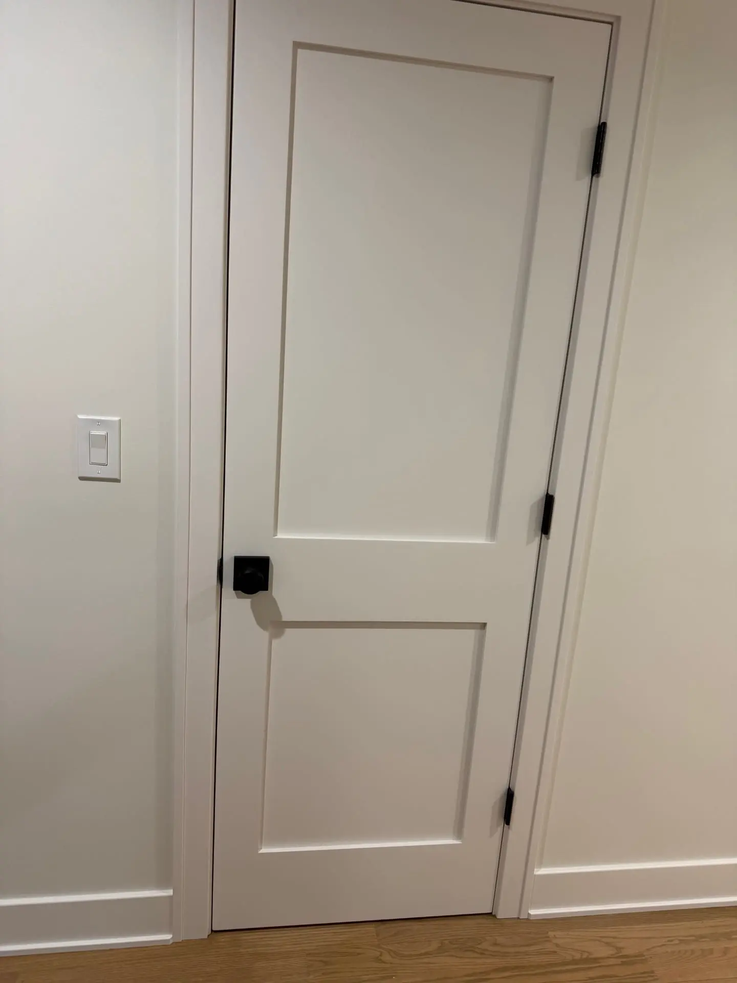 Fifteen interior doors installed in the Elmhurst Elm Estates subdivision with new trim molding, spray-painted finish, updated knobs, and adjusted stop molding.
