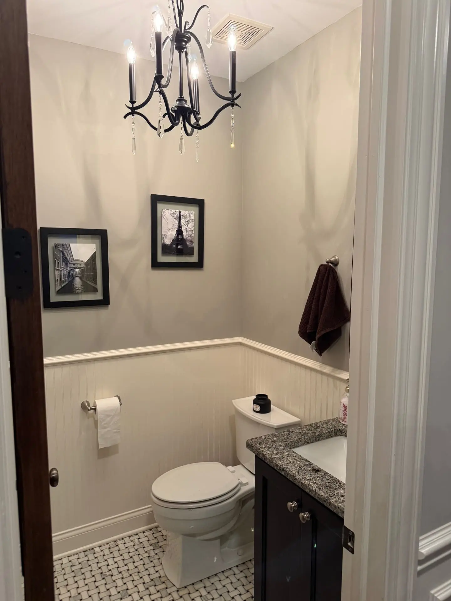 Freshly painted bathroom in Crescent Park, Elmhurst, IL, with repaired ceiling stain, refreshed walls and wainscoting, and a replaced light fixture.