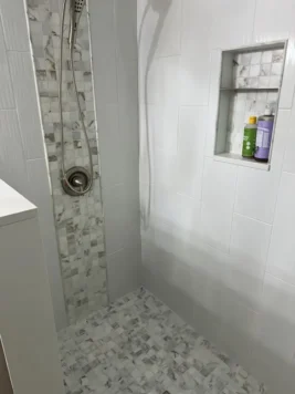 Shower Tile Installation with Waterfall Accent and Niche